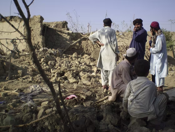 Tribesmen gather at a site of a missile attack on the outskirts of Miranshah, near the Afghan border, October 12, 2008. Due to the remote nature of the attacks, photos are rarely available.