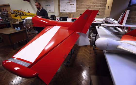 Salah Sukkarieh, professor of Robotics and Intelligent Systems at the University of Sydney, Australian Centre for Field Robotics, stands next to one o...
