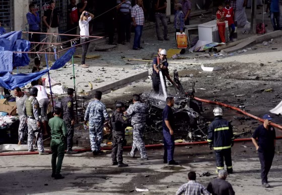 Security forces inspect the scene of a car bombing on Sadoun Street in Baghdad on Monday. A wave of attacks killed at least 57 people and wounded 168, officials said.