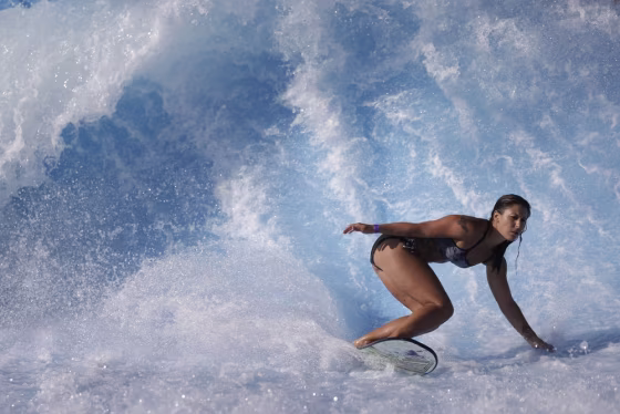 Sammantha Aker, of Huntington Beach, Calif., rides the machine-made wave at Wavehouse San Diego, Wednesday, Sept. 18, 2013, in San Diego.