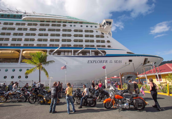 Passengers from a motorcycle cruises' tour group, prepare to board the Royal Caribbean International's Explorer of the Seas, docked at Charlotte Amali...