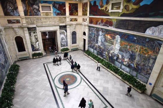 People look at a mural by artist Diego Rivera at the Art Institute of Detroit in December. Some of the art collection owned by the city of Detroit is in jeopardy of being auctioned off due to the city's bankruptcy. To keep the art from potential sale, a coalition of foundations and individuals has pledged $370 million to go toward pension benefits for retirees.