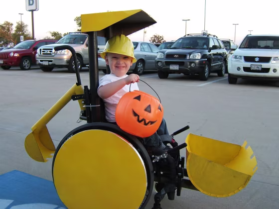 Child in wheelchair construction backhoe costume