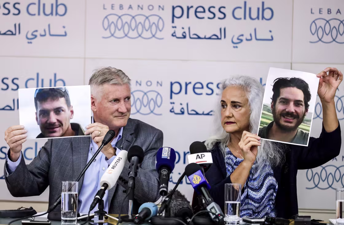 Marc and Debra Tice, parents of journalist Austin Tice, who was kidnapped in Syria in 2012, hold portraits of him at a news conference in Beirut in 2017.