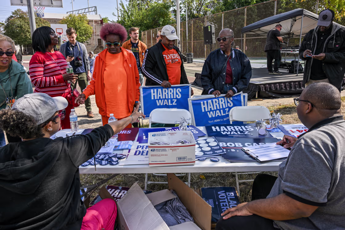 Harris-Walz campaign volunteers hand out campaign posters, yard signs and stickers in Philadelphia on Oct. 12.