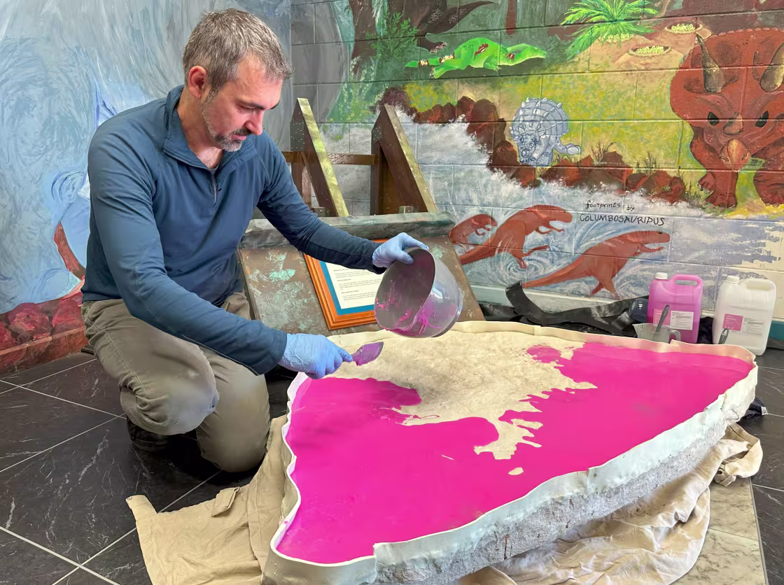 Romilio spreads silicone on a cast made from one of the rock samples.