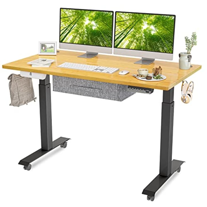 FEZIBO Standing Desk with Drawer, Adjustable Height Electric Stand up Desk, 48 x 24 Inches Sit Stand Home Office Desk, Ergonomic Workstation Black Steel Frame/Bamboo Wood Grain Tabletop