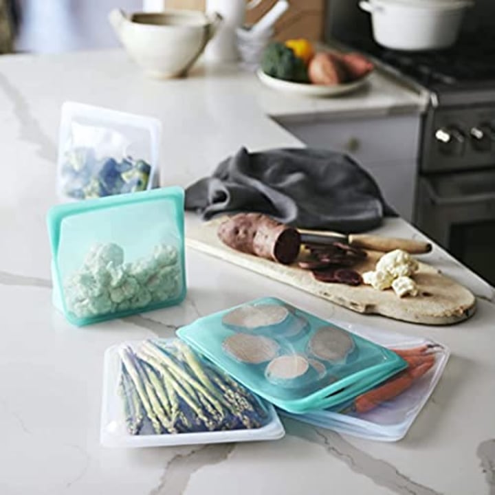 Stasher Silicone Reusable Storage Bag, Bundle 4-Pack Lunch (Clear+Aqua) | Food Meal Prep Storage Container | Lunch, Travel, Makeup, Gym Bag | Freezer, Oven, Microwave, Dishwasher Safe, Leakproof