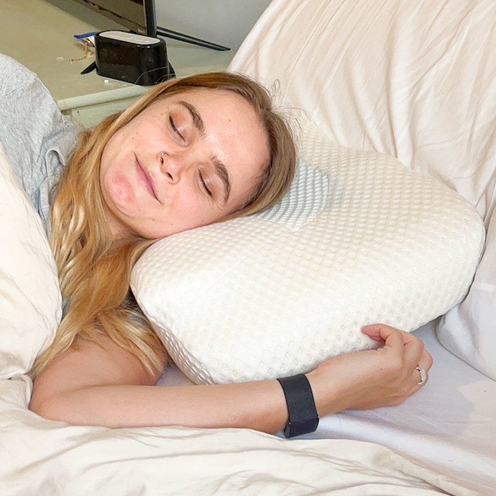 Woman sleeping on her side with a pillow