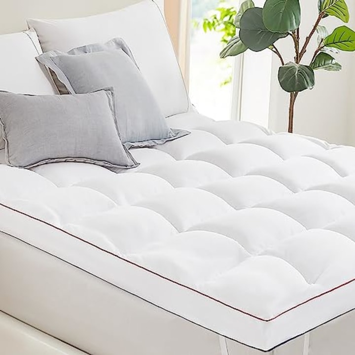 https://media-cldnry.s-nbcnews.com/image/upload/t_fit-720w,f_auto,q_auto:best/rockcms/2023-10/AMAZON-Timimi-Mattress-Topper-Queen---Cooling-Pillow-Top-Mattress-Topper-Queen-Size-Extra-Thick-Plush-Bed-Topper-Down-Alternative-Overfilled-Soft-Mattress-Pad-for-Back-Pain-8bf9cb.jpg