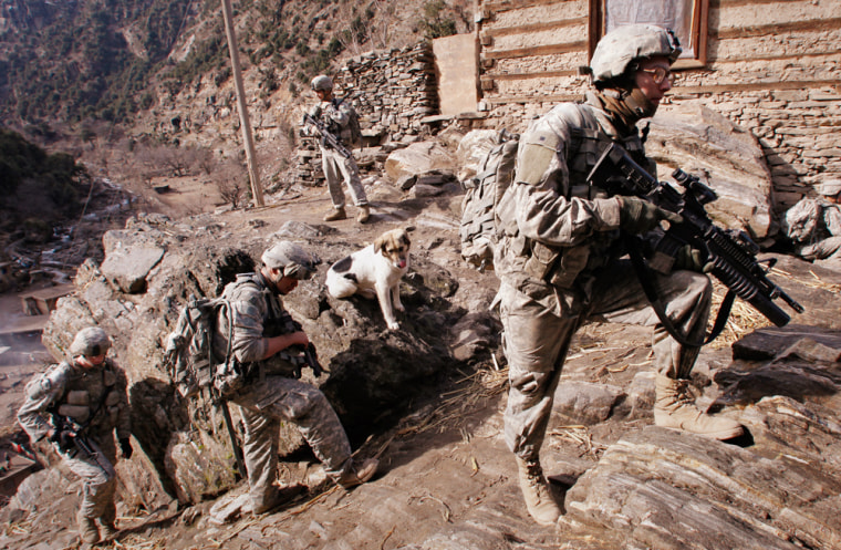 Image: Soldiers with U.S. Army's 6-4 Cavalry take up hilltop position during patrol near Combat Outpost Keating in eastern Afghanistan
