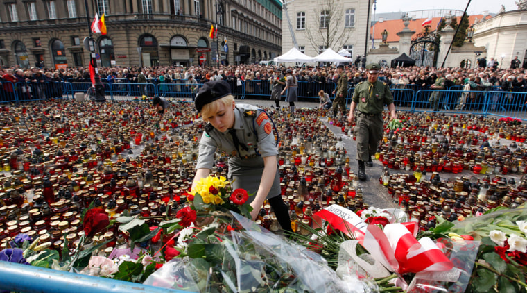 Image: Woman lays flowers on square near the Presidential Palace in Warsaw