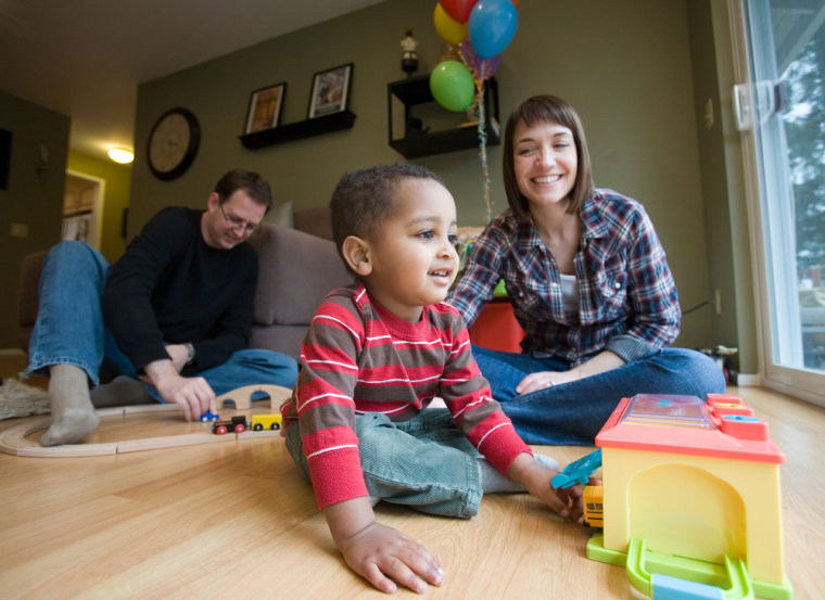 Image: Binyam Kalning, two-year-old, playing with his adopted parents Steve and Kristin.