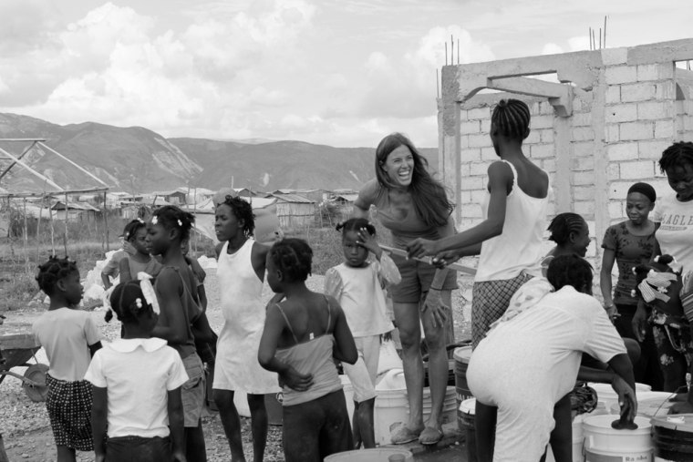 Kelly Bensimon pumps clean water for the women living in Camp Canara, one of the many tent cities where Haiti earthquake survivors are now living. Kelly hopes to help fund another water well for the women in this area.