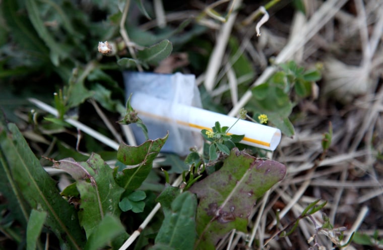 Image: A heroin pouch lies next to a sidewalk on Chicago's Homan Avenue.