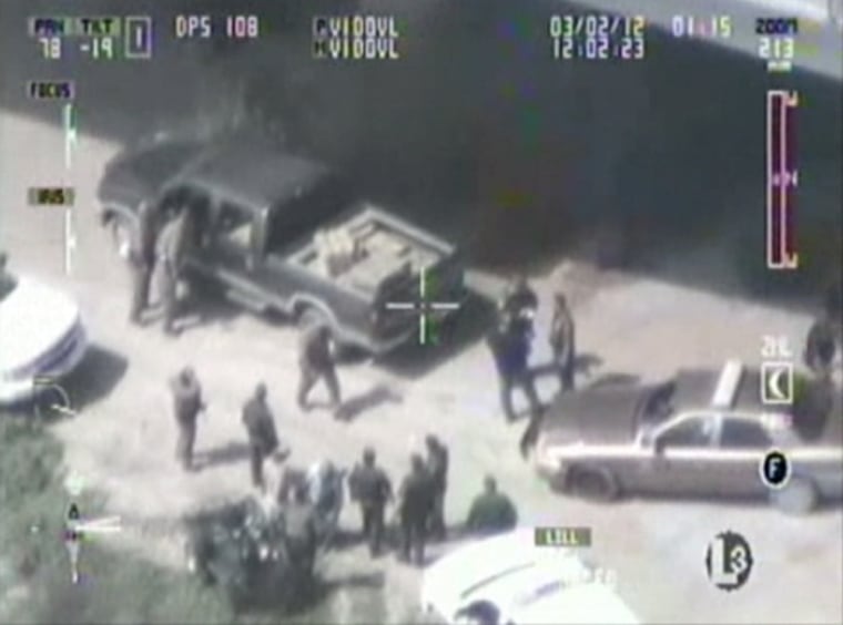 Officers surround a truck loaded with marijuana in South Texas during a drugs bust on the US Mexico border.