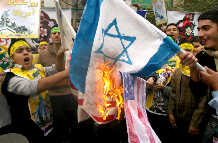 Image: Iranian students burn the U.S and Israel flags