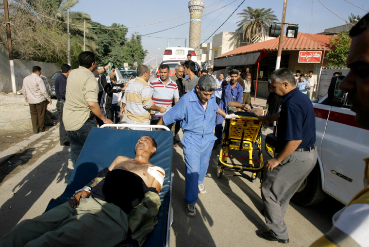 Image: Injured men are transported to Ibn al-Nafees hospital.