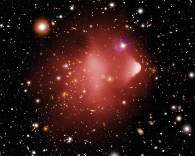 The Bullet Cluster, located about 3.8 billion light years from Earth, formed after a violent collision of two giant clusters of galaxies. This image combines an X-ray image from Chandra with an optical data from the Hubble Space Telescope and the Magellan telescope in Chile. 