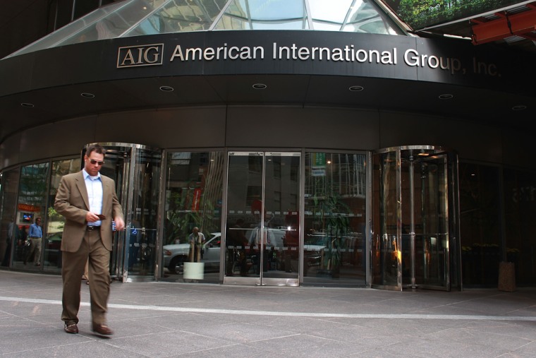 Image: Pedestrians walk in front of a American International Group, Inc