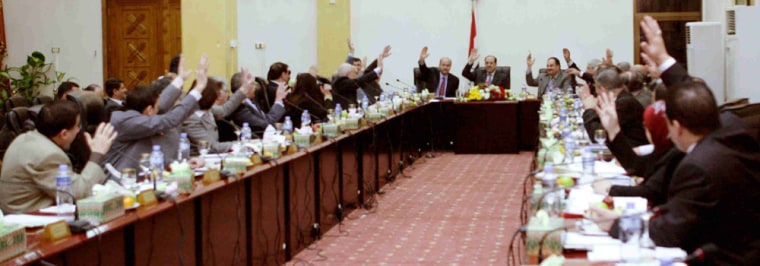 Image: In this image released by the Iraqi government, Iraq's Cabinet votes to approve a security pact with the United States