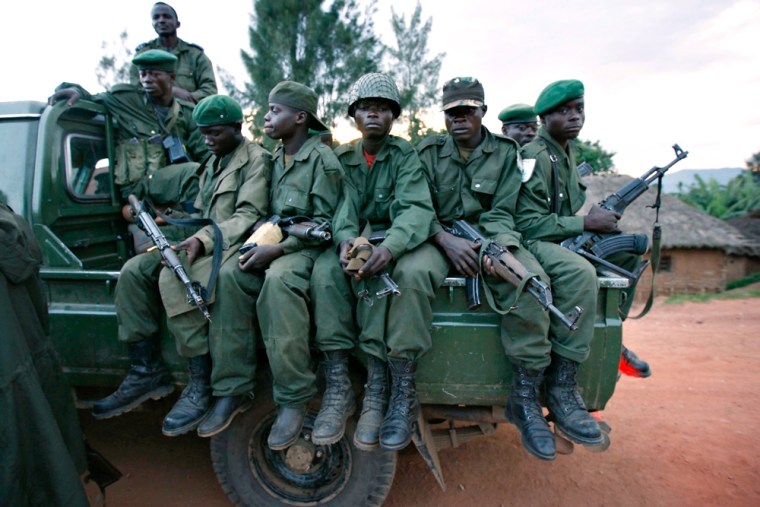 Image: Government troops ride a vehicle while leaving the town of Kanyabayonga in eastern Congo