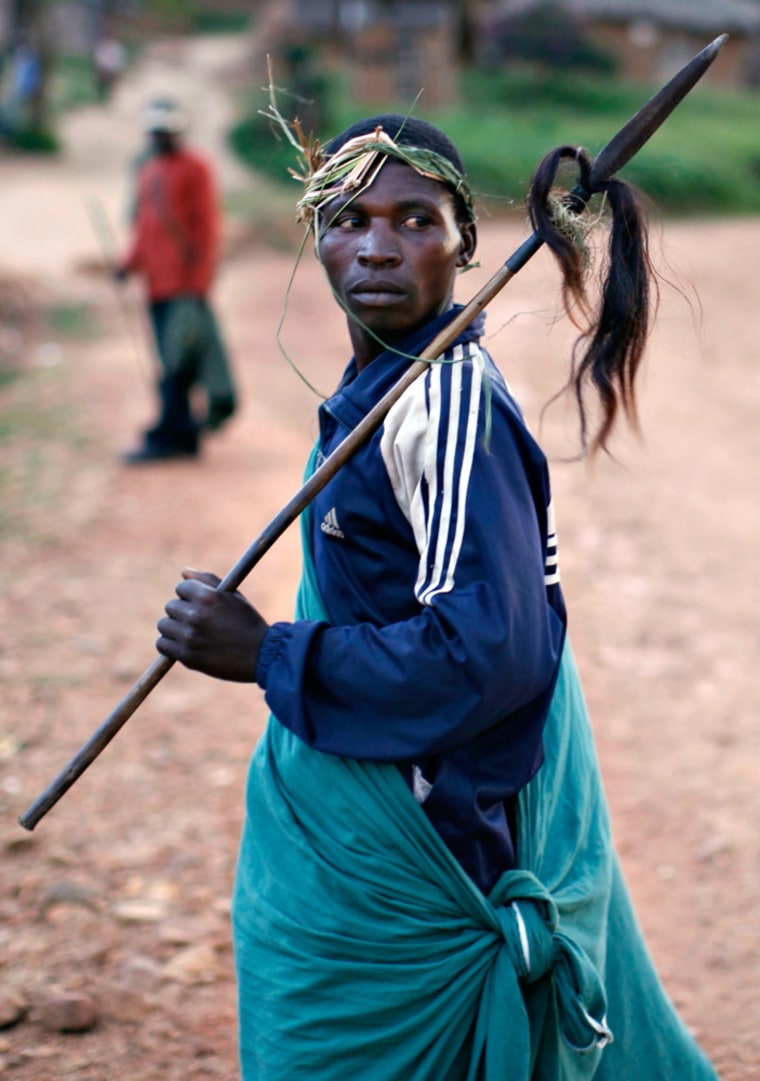 Image: Traditional Mai Mai militia fighter walks in the town of Kanyabayonga in eastern Congo