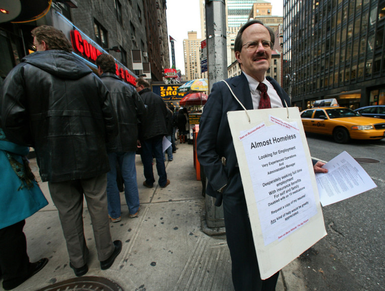 Paul Nawrocki, from Beacon, N.Y., wears a sign as he looks for work near the David Letterman studios in New York, Tuesday Nov. 18,  2008. After nine fruitless months of looking for work, Nawrocki has turned to a Depression-era tactic to try to land himself a job. (AP Photo/Bebeto Matthews)