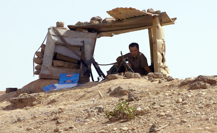 Image: A Kurdish peshmerga fighter mans his position in the northeastern town of Khanaqin
