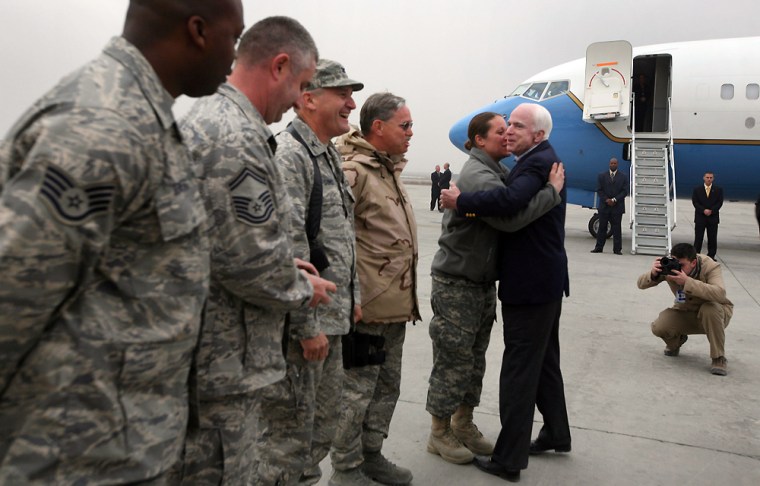 Image: U.S. Sen. John McCain, center, hugs an unidentified serviceperson before getting into an airplane to leave from Kabul airport in Kabul, Afghanistan