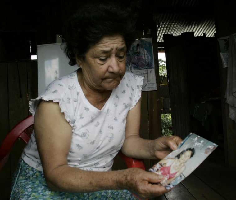 Mercedes Jimenez shows a photograph of her daughter Mercedes Jaramillo, who suffers from skin problems which her family fear is skin cancer, in her home in Lago Agrio, Ecuador on Aug. 4, 2008. The Amazon Defense Coalition claims that Texaco haphazardly dumped 18 billion gallons of toxic wastewater in virgin forests and, as a result, residents suffered abnormally high cancer rates. (AP Photo/Dolores Ochoa)