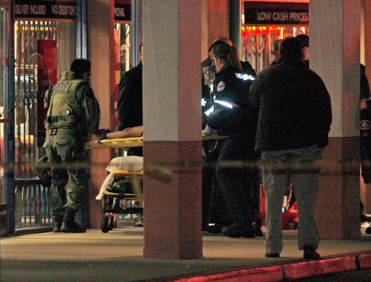 Image: Paramedics and SWAT team officers carry out a boy on a stretcher after being rescued from the a Chinese restaurant