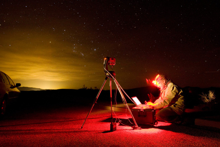 Image: Dan Duriscoe works at a special computer controlled camera used to photograph the night sky at Dantes View in Death Valley