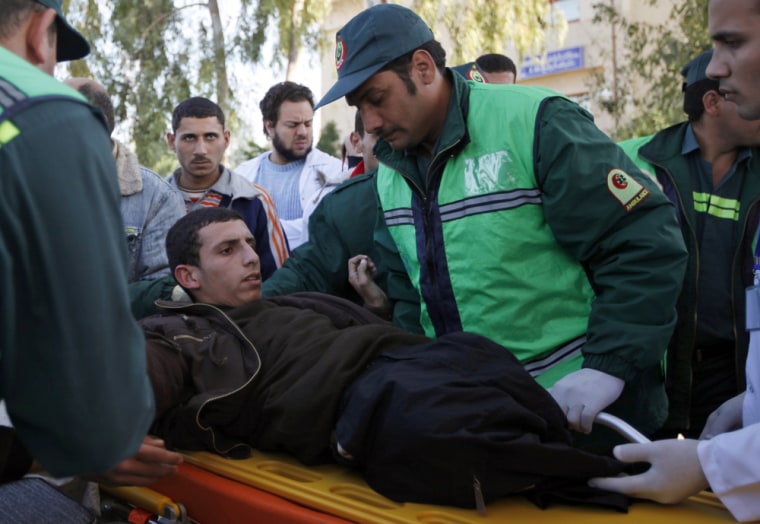 Image: Egyptian paramedics evacuate an injured Palestinian man