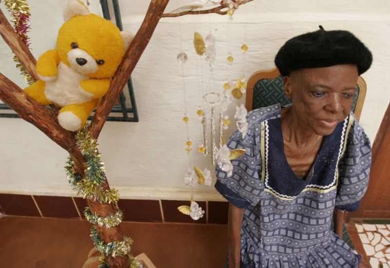 An unidentified patient sits near a memorial tree in the hospice at the Tapalogo project in Phokeng, Rustenburg, South Africa, Friday, Dec. 19, 2008. With funding help from the U.S. government Tapologo provides a comprehensive and holistic response to the HIV/AIDS-related health needs of the communities surrounding the town. Their full range of services includes outreach, antiretroviral treatment (ART), blood testing in a shipping container converted laboratory, and an orphans and vulnerable children program. (AP Photo/Denis Farrell)