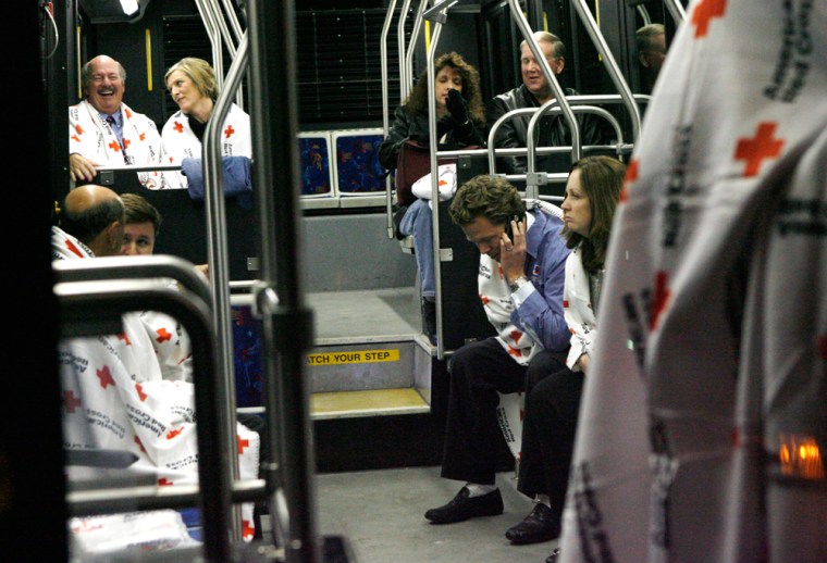 Survivors of the US Airways plane crash in the Hudson River wait for a bus to take them from a First Aid center in Weehawken, N.J. back to La Guardia Airport, Thursday, Jan. 15, 2009. (AP Photo/Stuart Ramson)