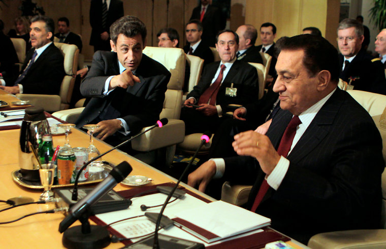 Image: French President Nicolas Sarkozy, center, gestures as he chairs with Egyptian President Hosni Mubarak