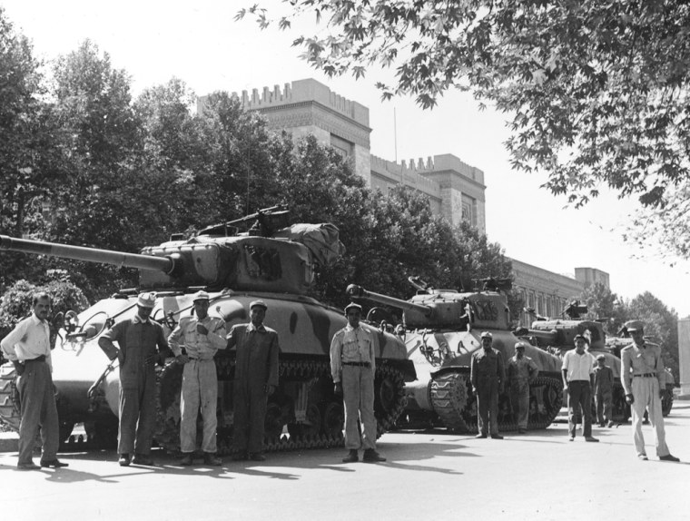 Iranian army troops and tanks stand in front of Central Police headquarters after the attempted coup d'etat against Iranian Premier Mohammad Mossadeq in Tehran, capital of Iran, Aug. 16, 1953. The coup, engineered by the United States and Britain supporting Mohammad Reza Shah Pahlavi, failed after supporters of Mossadeq rioted. The Shah fled to Italy. On Aug. 19, the premier was ousted and the Shah of Iran was restored to power. (AP Photo)