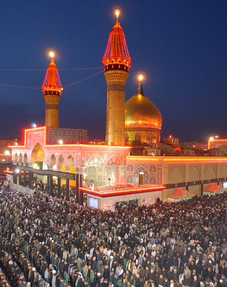 A day before the 10th day of Ashoura, Shiite Muslims offer afternoon prayers at the Imam Hussein holy shrine in Karbala, Iraq, Monday March 1, 2004. Hundreds of thousands of Shiite Muslims from around the world are gathering with Iraqis for the Shiite religious festival which marks the battle of year 680 A.D. in which Imam Hussein, the grandson of Islam's Prophet Mohammed, was killed. During the rule of Iraqi President Saddam Hussein, such rituals were banned in Iraq.(AP Photo/Hussein Malla)
