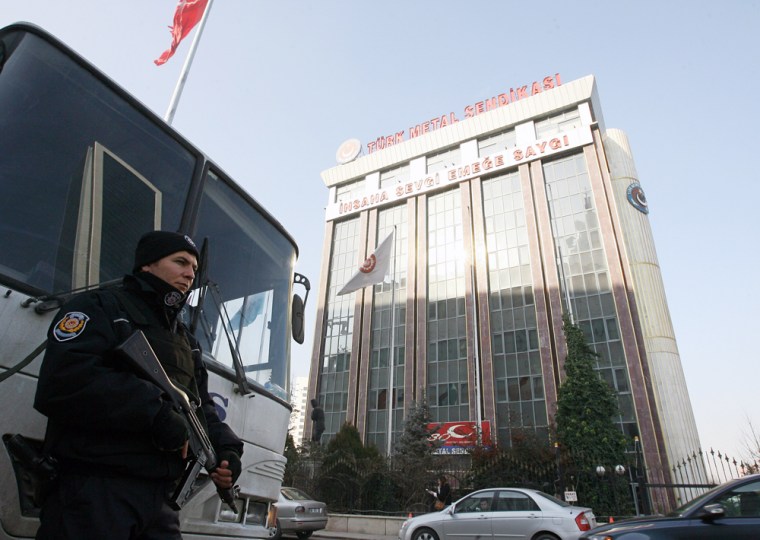 Image: A police officer stands outside the headquarters of Turkey's Metal Workers' Union