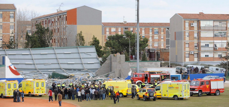 Image: Rescuers work in part of a sports center which collapsed in high winds killing four children and trapping and injuring others in Sant Boi Llobregat, Spain