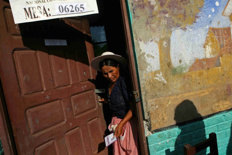 An Aymara Indian woman holds her ballot before casting it Sunday at a polling station in the coca growing village of Villa 14 de Septiembre in central Bolivia. 