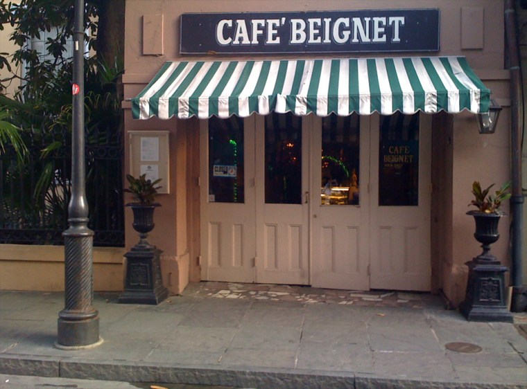 People, and cats, gather in the French Quarter's Cafe Beignet.