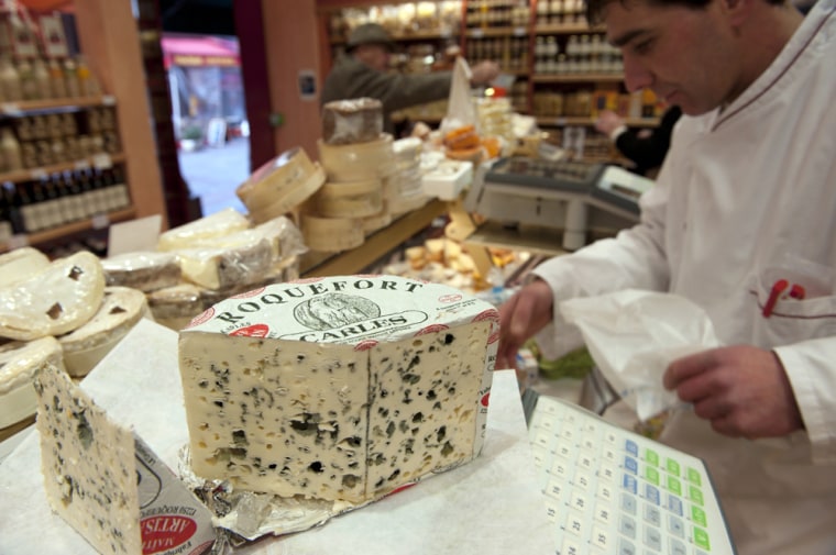 Image: A piece of French Roquefort blue cheese is displayed in a shop in Paris