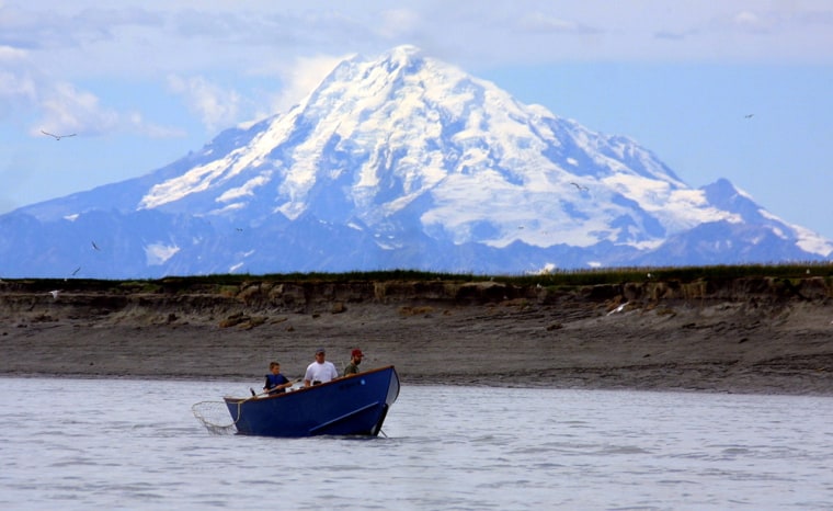 Image: Mount Redoubt volcano on the horizon, near the mouth of the river at Kenai, Alaska.