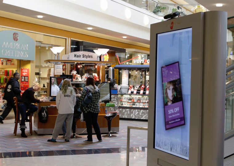 Image: Shoppers are shown near an advertising kiosk at the Hanes Mall in Winston-Salem, N.C.