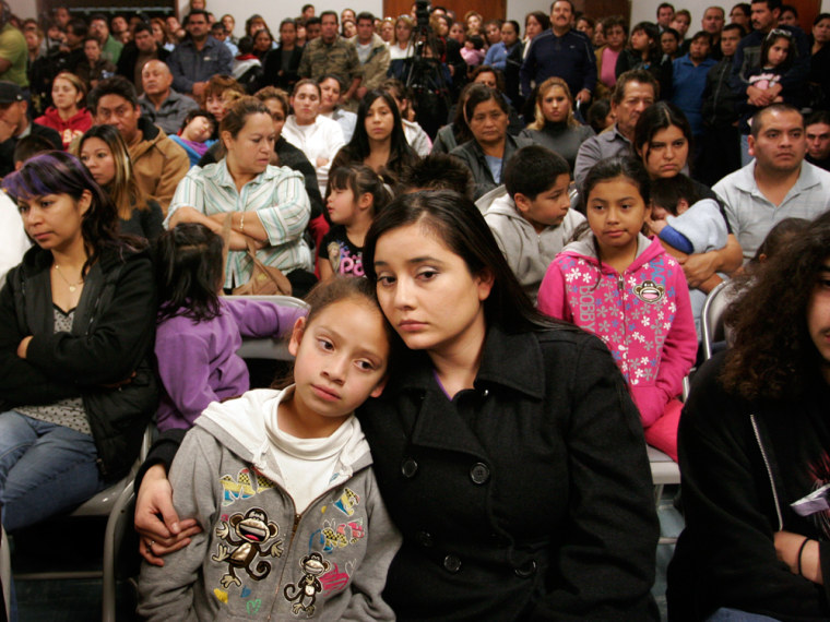 Image: Rebecca Avila, 27, right, with her goddaughter Jessica Urquieta, 9, attend a community meeting at Holy Family Church in Wilmington, Calif.