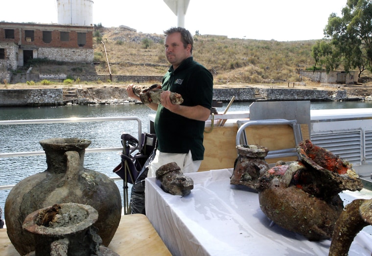 U.S. archaeologist Jeffrey G. Royal seen here with some of the treasures found in the waters off southern Albania. The project would not have been imaginable just 18 years ago, when the country was ruled by Communists who banned contact with the outside world.