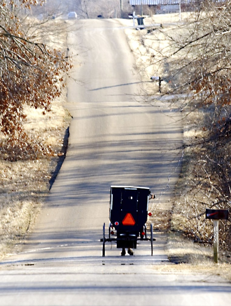 A horse and buggy take an Amish family back to their home in Mayfield, Ky., on Wednesday.