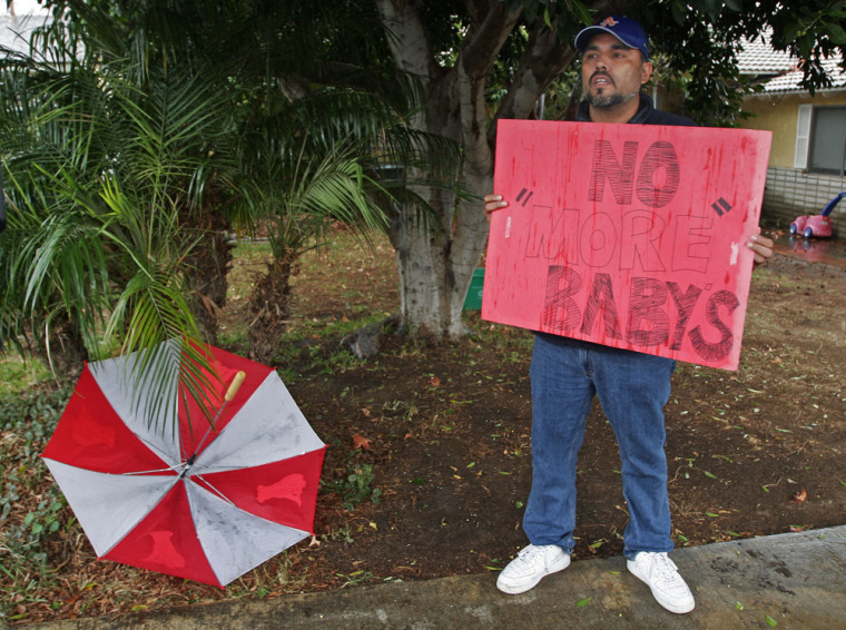 Image: Ulyses Gutierrez holds a sign